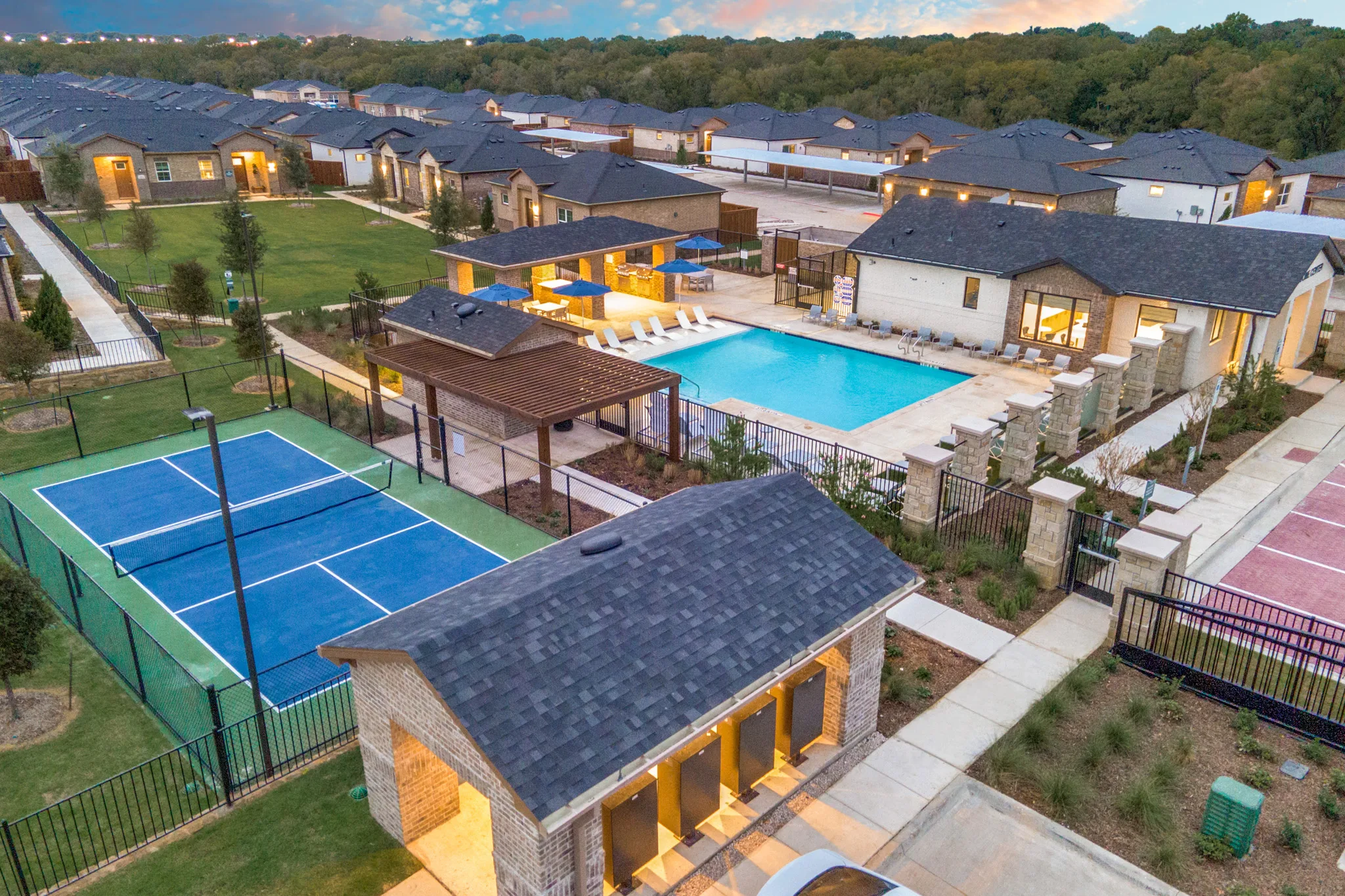 Aerial view of pickleball court, pool, and large lawn bird eye view